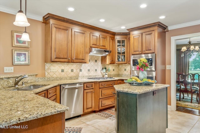 kitchen featuring a sink, under cabinet range hood, light tile patterned flooring, and stainless steel appliances