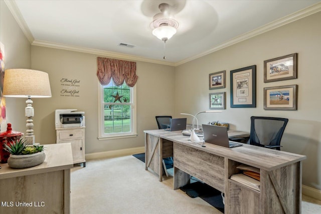 office space with baseboards, light colored carpet, ornamental molding, and visible vents