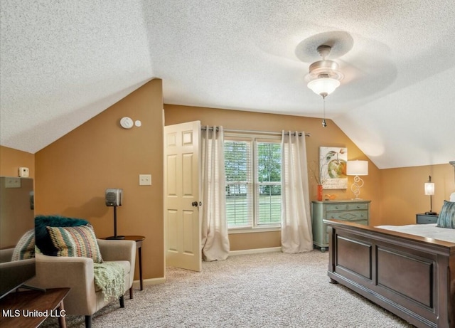 bedroom featuring a textured ceiling, vaulted ceiling, light carpet, and baseboards