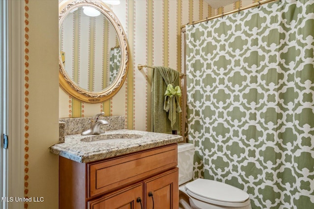 bathroom featuring vanity, toilet, wallpapered walls, and a shower with shower curtain