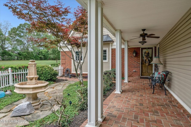 view of patio / terrace featuring fence and a ceiling fan