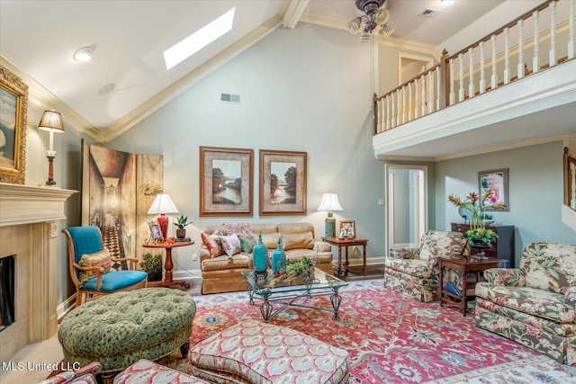living room featuring high vaulted ceiling, visible vents, a skylight, and a fireplace