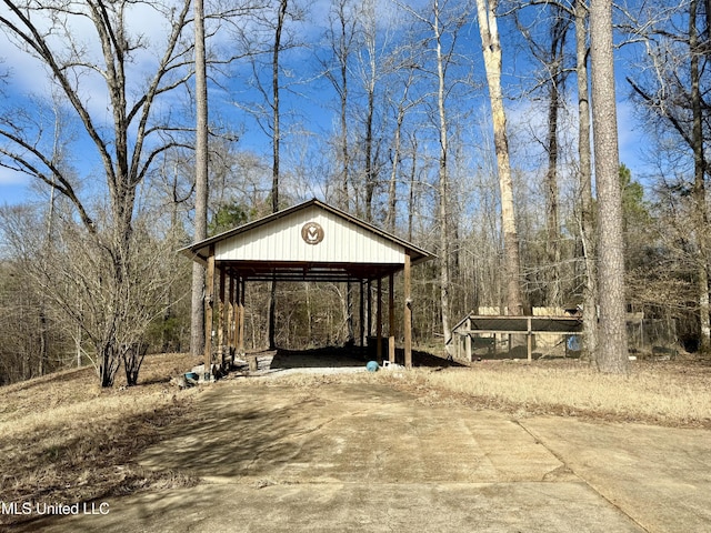 view of outbuilding with a detached carport, driveway, and a gazebo