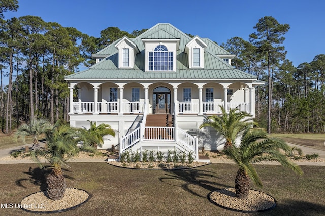 view of front of house featuring covered porch and a front yard