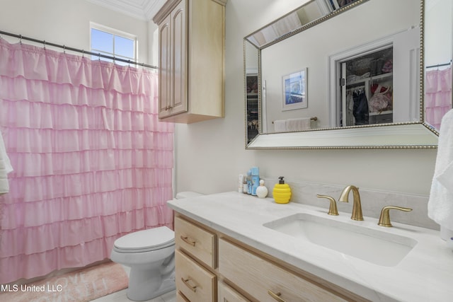 bathroom with vanity, toilet, and ornamental molding