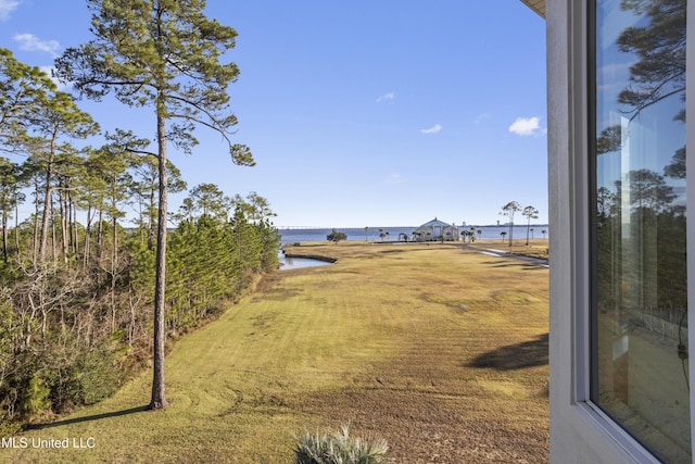 exterior space featuring a lawn and a water view