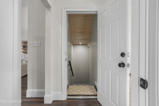 stairway with hardwood / wood-style floors and wooden ceiling