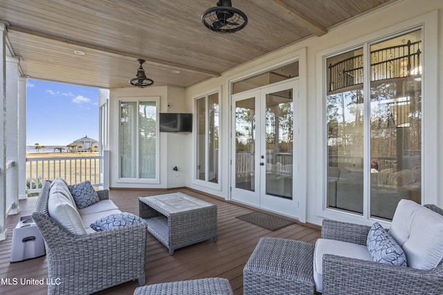 exterior space featuring outdoor lounge area, ceiling fan, and french doors