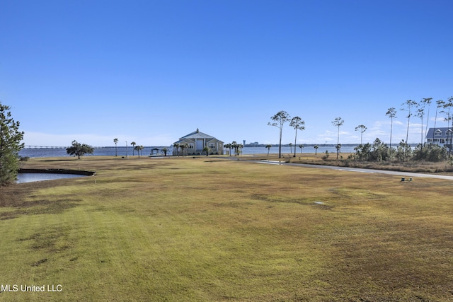 view of property's community featuring a yard and a water view