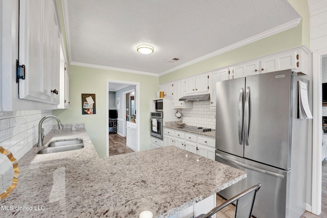 kitchen featuring wood-type flooring, stainless steel appliances, white cabinetry, and sink