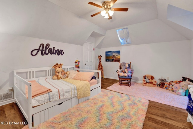 bedroom featuring ceiling fan, dark hardwood / wood-style flooring, and lofted ceiling