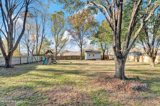 view of yard featuring a storage shed and a playground