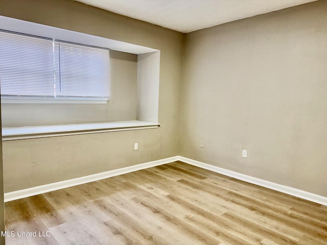 spare room featuring light hardwood / wood-style flooring