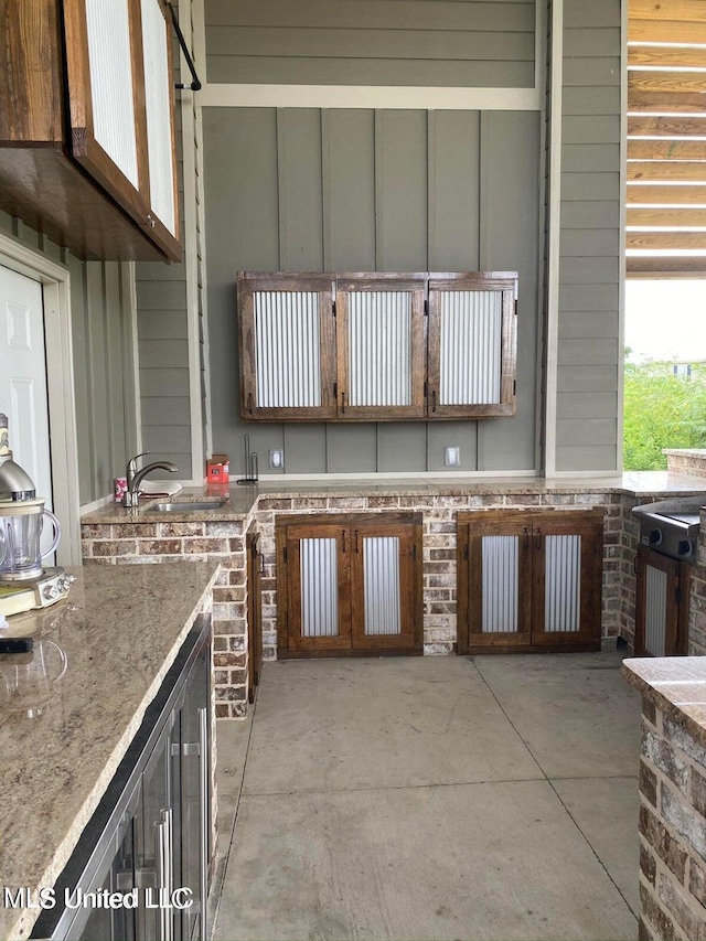 view of patio featuring area for grilling and sink