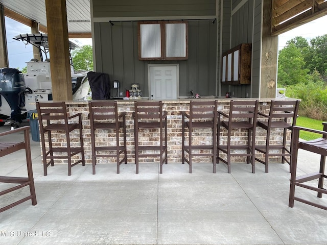 view of patio featuring a grill and a bar