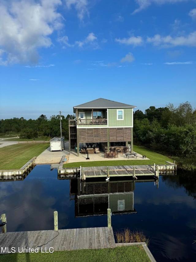 view of dock with a patio area and a water view