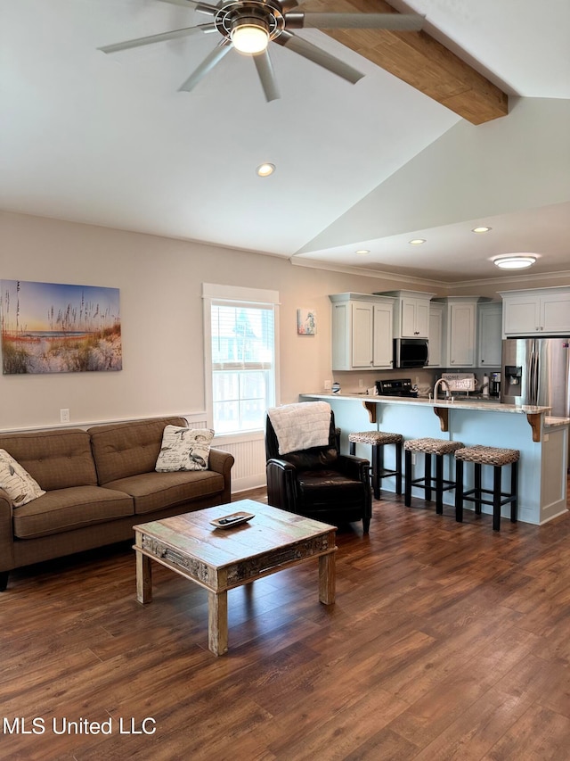 living room with vaulted ceiling with beams, dark hardwood / wood-style floors, and ceiling fan