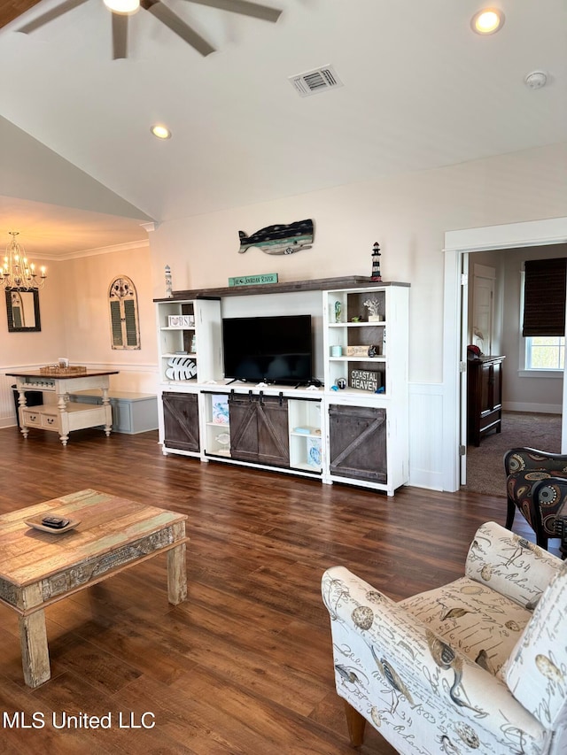 living room featuring ceiling fan with notable chandelier, wood-type flooring, and vaulted ceiling