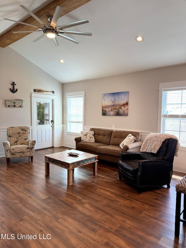 living room with dark hardwood / wood-style flooring, lofted ceiling with beams, and a healthy amount of sunlight