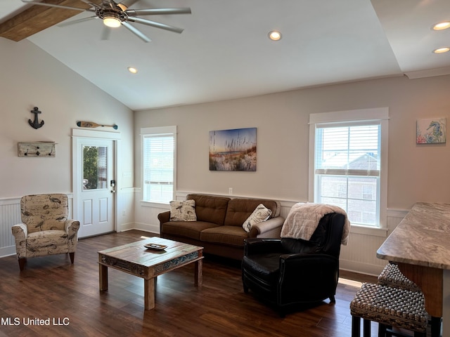 living room with vaulted ceiling with beams, a healthy amount of sunlight, dark hardwood / wood-style flooring, and ceiling fan