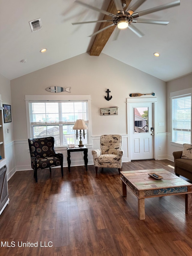 living room with vaulted ceiling with beams, plenty of natural light, ceiling fan, and dark hardwood / wood-style flooring