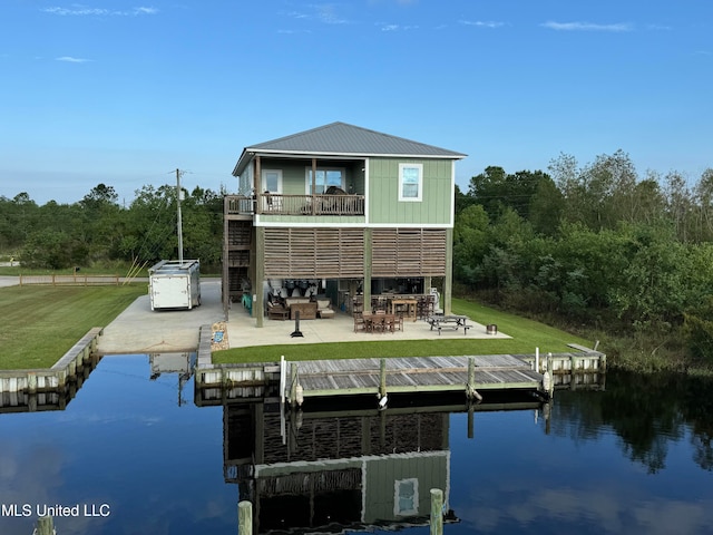 back of property featuring outdoor lounge area, a water view, a balcony, and a patio