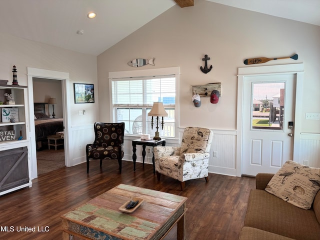 living room with lofted ceiling with beams and dark wood-type flooring