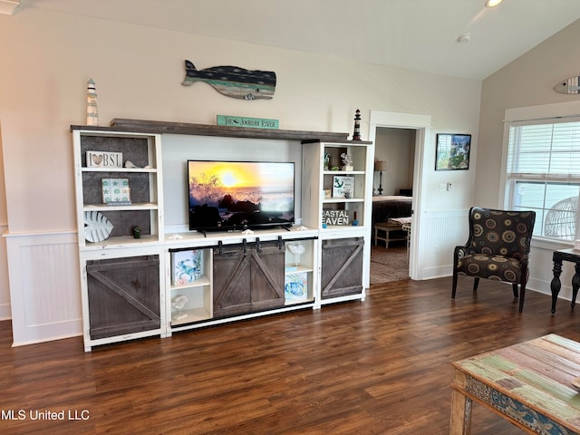 living room with dark hardwood / wood-style flooring and lofted ceiling