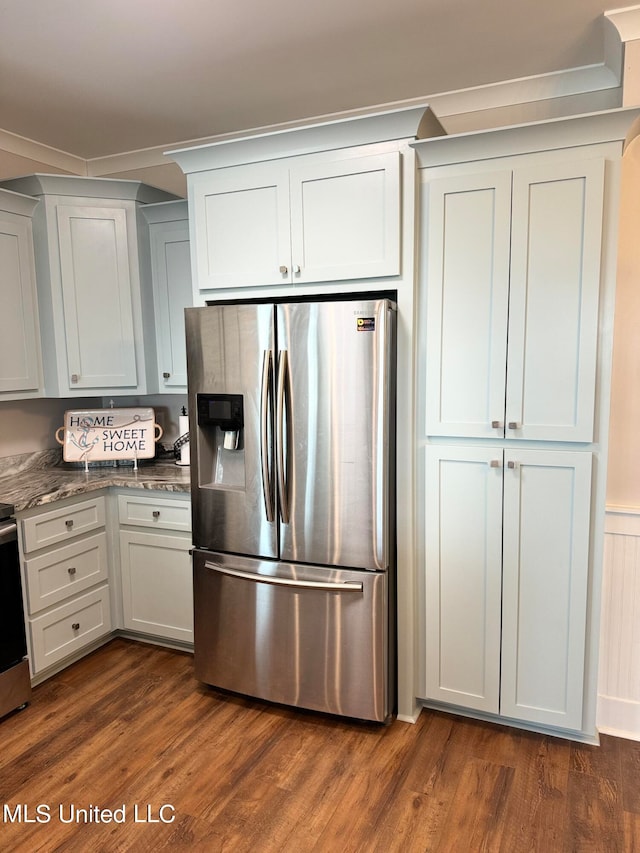 kitchen featuring white cabinets, dark hardwood / wood-style flooring, stainless steel refrigerator with ice dispenser, and stone counters