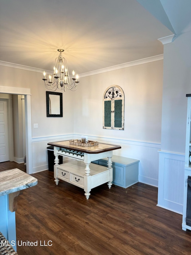 unfurnished dining area featuring dark hardwood / wood-style flooring, crown molding, and an inviting chandelier