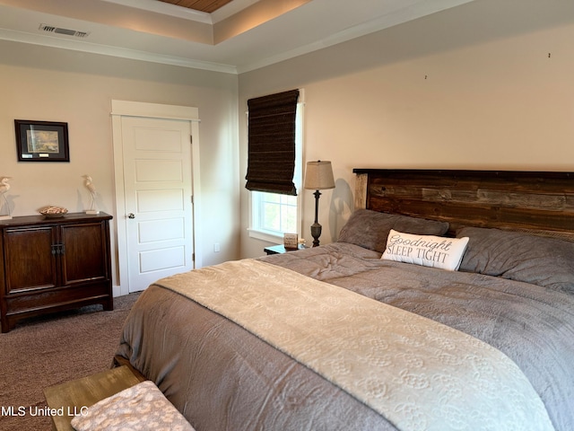 carpeted bedroom featuring a raised ceiling, a closet, and ornamental molding