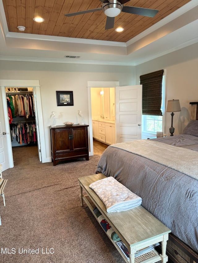 carpeted bedroom with a tray ceiling, ceiling fan, a closet, and wood ceiling