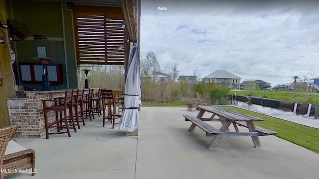 view of patio / terrace with a bar and a water view