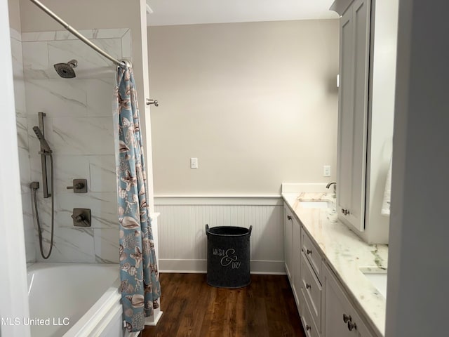 bathroom with hardwood / wood-style floors, vanity, and shower / tub combo with curtain