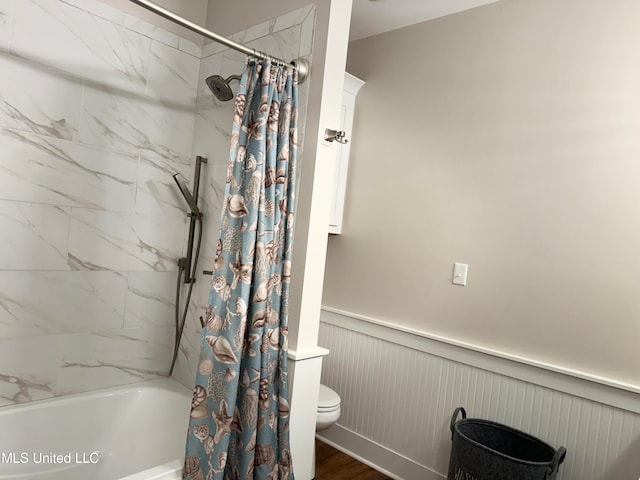 bathroom featuring shower / bathtub combination with curtain and toilet