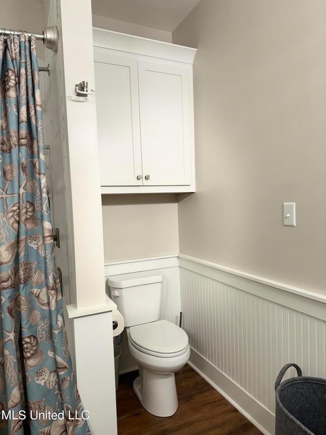 bathroom featuring a shower with shower curtain and hardwood / wood-style flooring