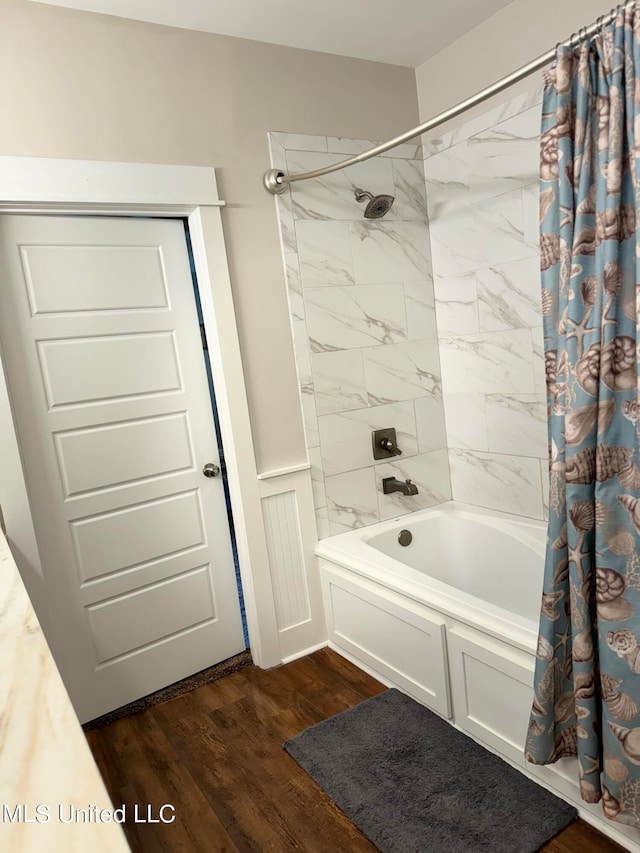 bathroom with shower / bath combo with shower curtain and hardwood / wood-style flooring