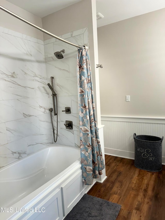 bathroom with shower / bath combo and hardwood / wood-style flooring