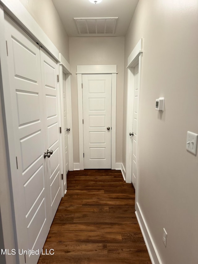 corridor with dark wood-type flooring