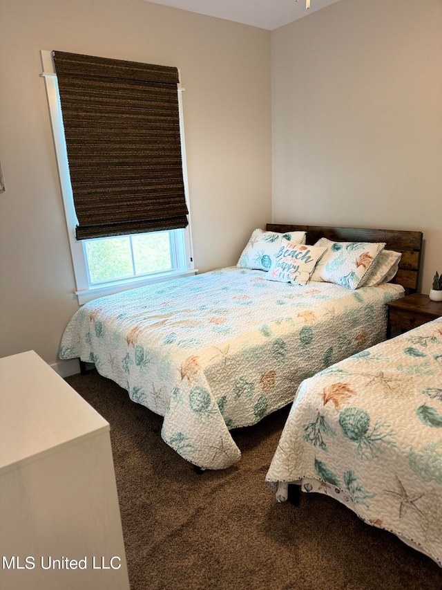 bedroom featuring dark colored carpet