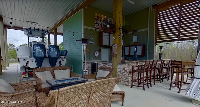 view of patio featuring a bar and an outdoor fire pit