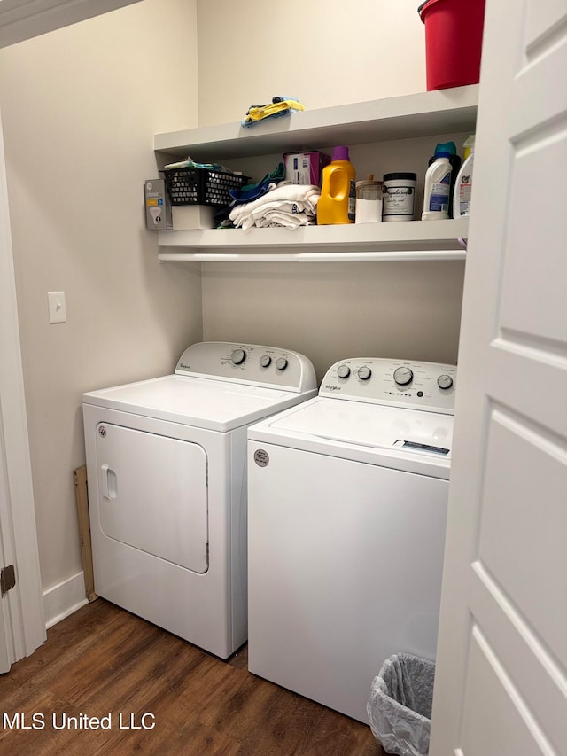 laundry area featuring washing machine and dryer and dark hardwood / wood-style floors