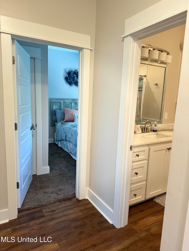 hall with dark hardwood / wood-style flooring and sink