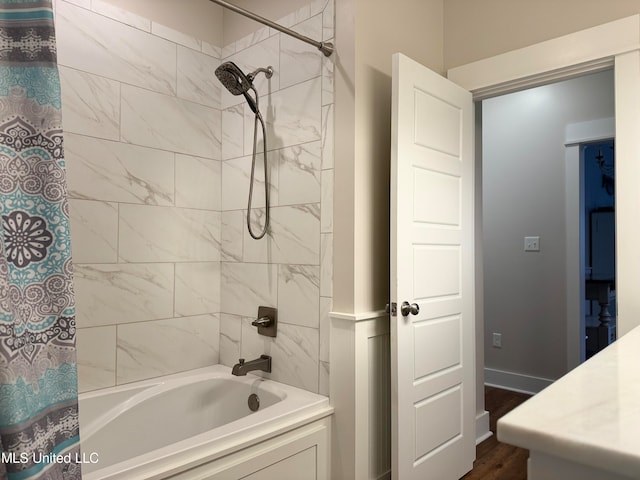 bathroom with hardwood / wood-style floors and shower / tub combo with curtain