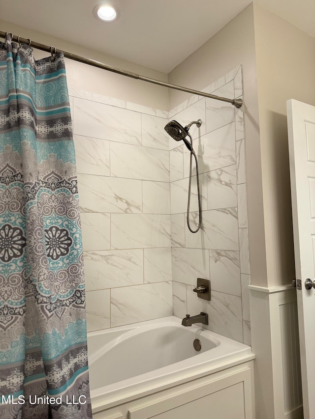 bathroom with shower / bath combo with shower curtain