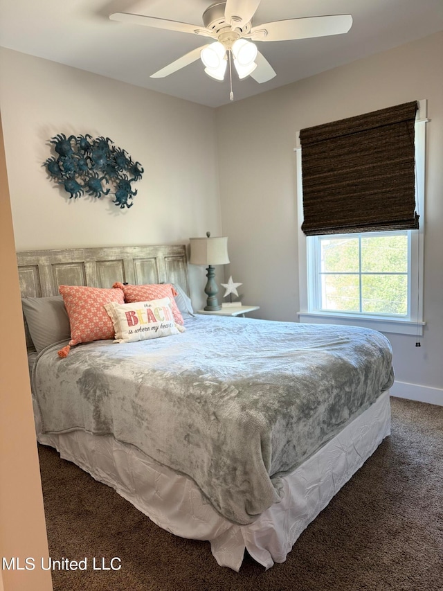 bedroom with dark colored carpet and ceiling fan