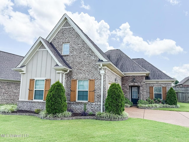3041 Brambleberry Cv, Southaven, MS 38672 - view of front facade with board and batten siding, brick siding, a front lawn, and roof with shingles