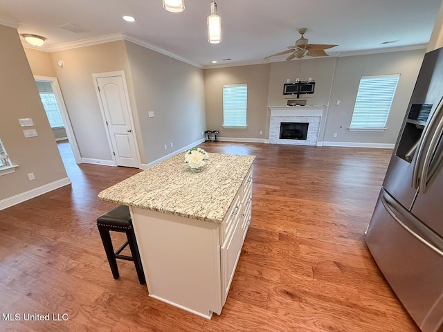 3041 Brambleberry Cv, Southaven, MS 38672 - kitchen featuring stainless steel fridge, a ceiling fan, healthy amount of natural light, white cabinetry, and ornamental molding