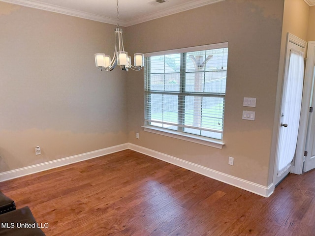 3041 Brambleberry Cv, Southaven, MS 38672 - unfurnished dining area featuring a chandelier, crown molding, and dark wood-type flooring