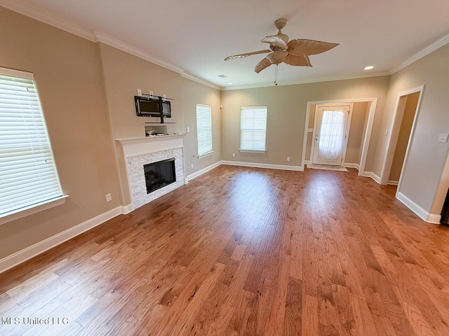 3041 Brambleberry Cv, Southaven, MS 38672 - unfurnished living room with ceiling fan, a stone fireplace, wood finished floors, and crown molding